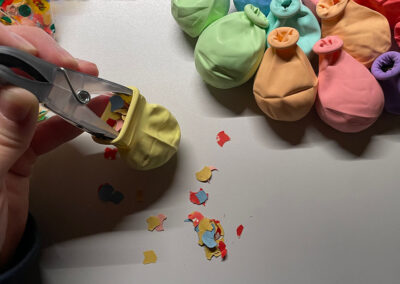 Zeitluftballon wird mit Konfetti und Aufgaben-Zettel befüllt